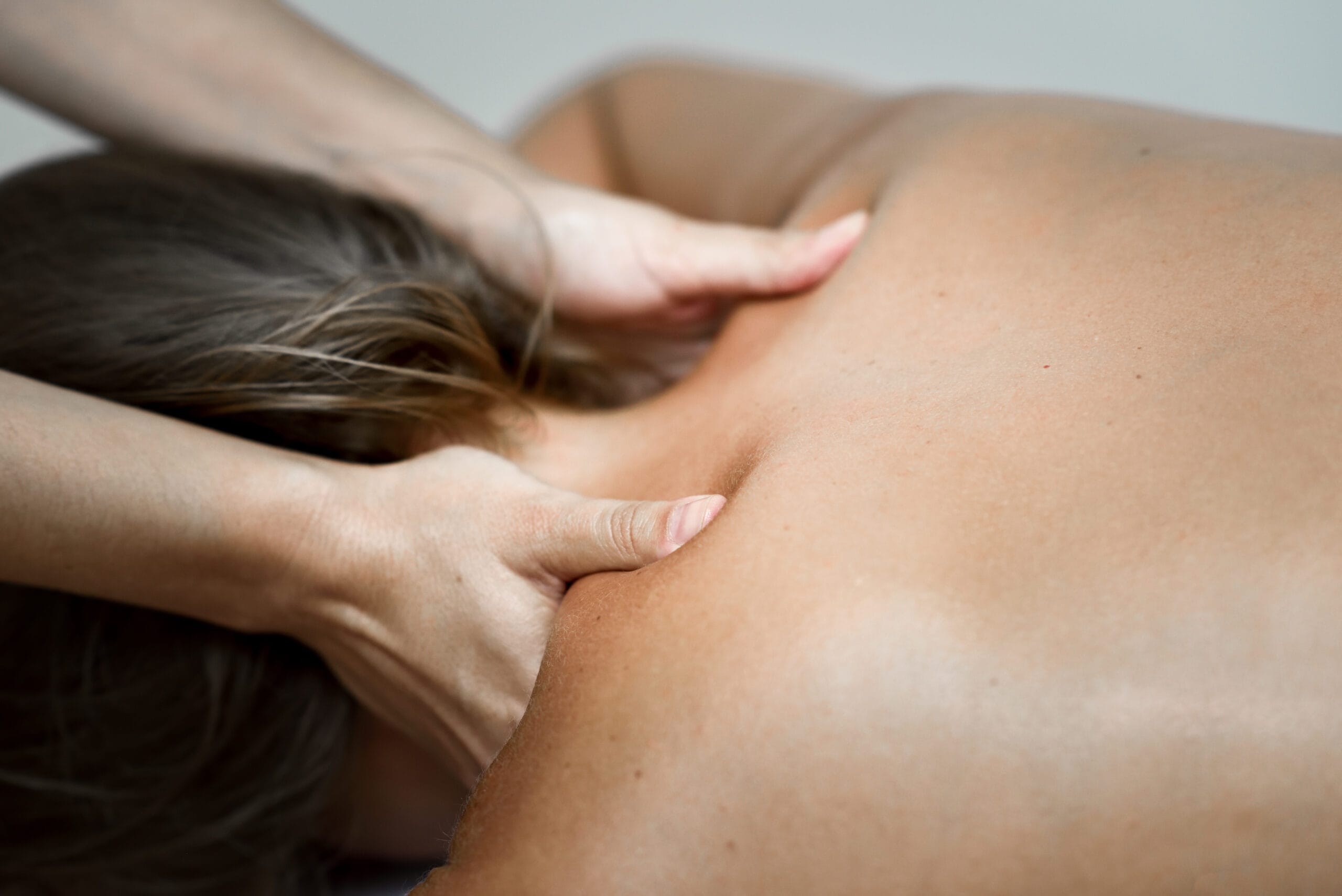 Young woman receiving a back massage in a spa center. deep tissue massage